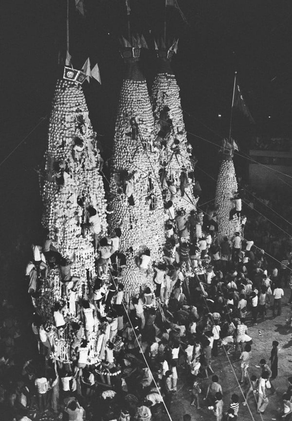People clamber up the Cheung Chau bun towers, moments before two of the towers collapsed. Picture: SCMP