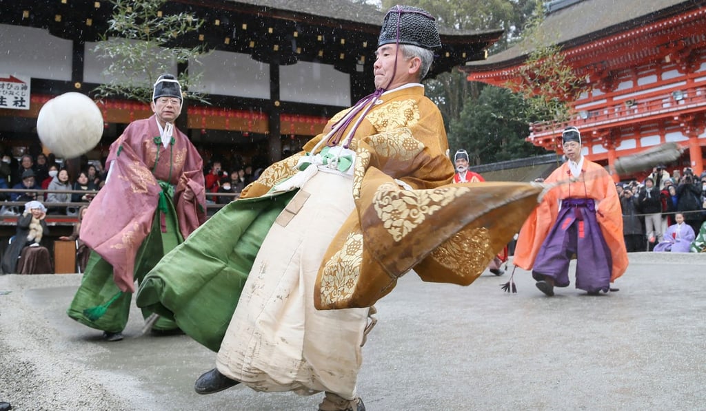 Players wearing ancient Japanese costumes kick a ball during the new year’s “Kemari” game, at the Shimogamo shrine in Kyoto on January 4. The eight-player game originally came from China almost 1,400 years ago. Photo: AFP