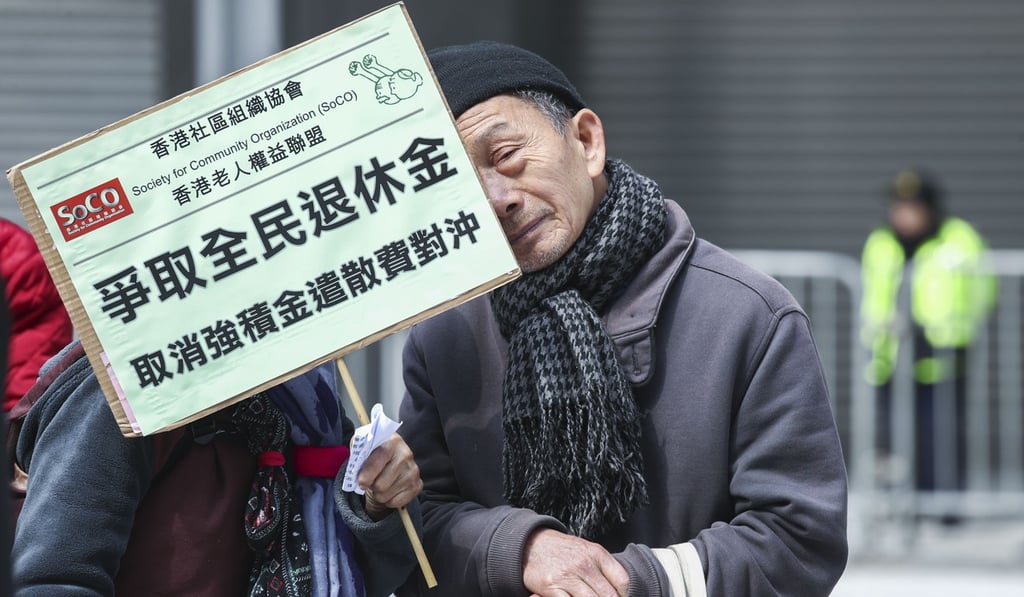 The Society for Community Organisation calls on the government to scrap the MPF offsetting mechanism and introduce a universal pension fund, at a rally outside government offices in Tamar in February. Photo: Nora Tam