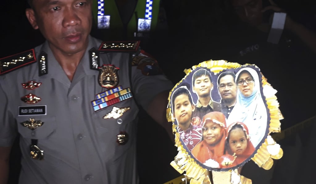 Surabaya police chief Rudi Setiawan with a picture of the family who carried out suicide bomb attacks at churches on East Java. Photo: AP