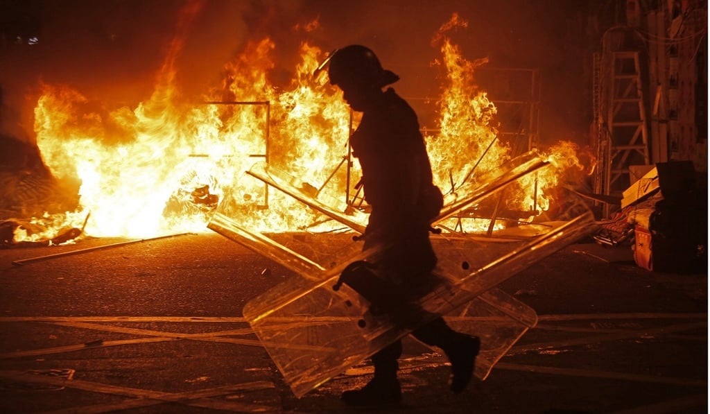 Rioters set the streets on fire and threw bricks at police during the unrest in Mong Kok. Photo: AP