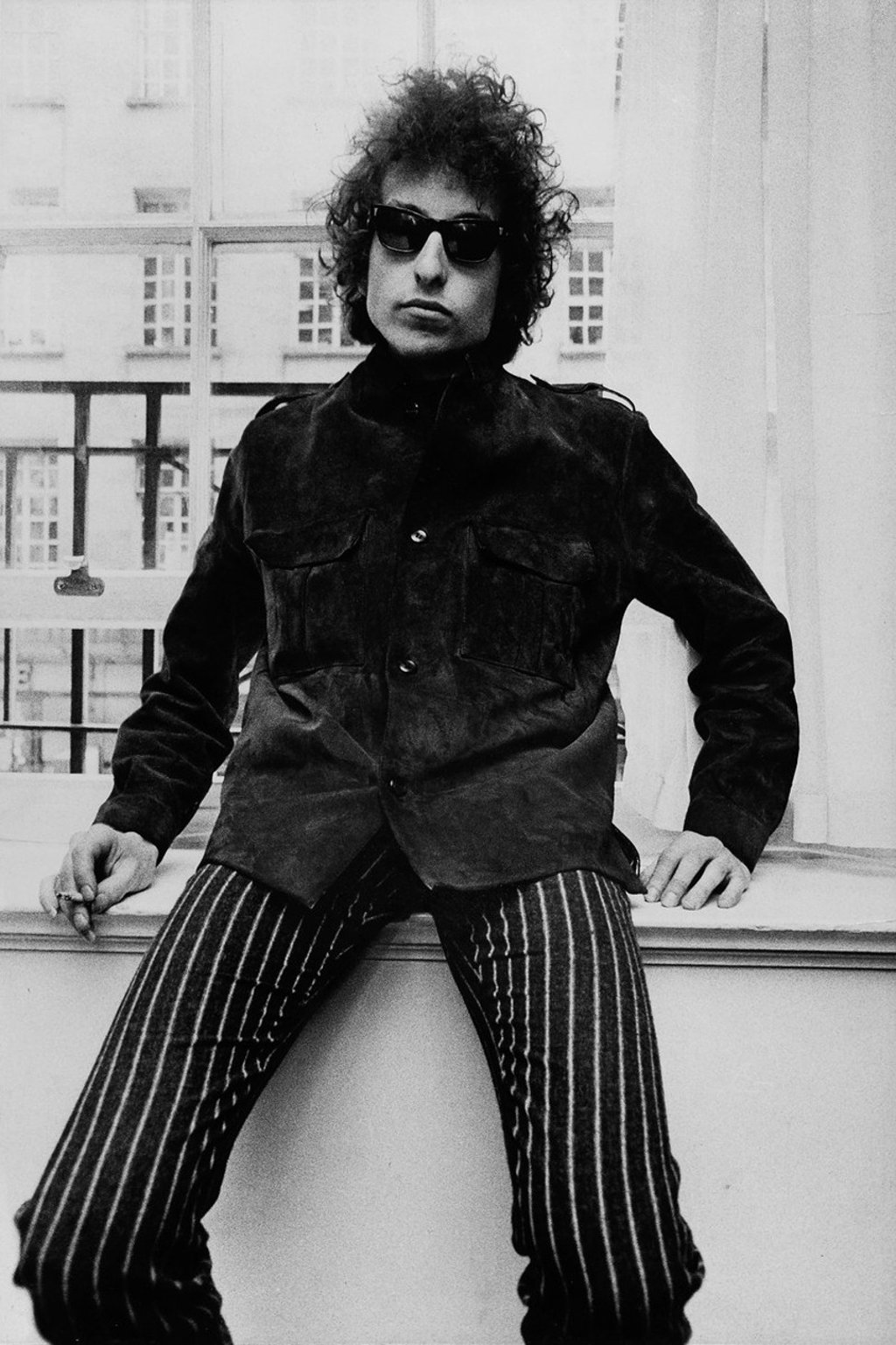 Bob Dylan wears his iconic Ray-Ban Wayfarers.