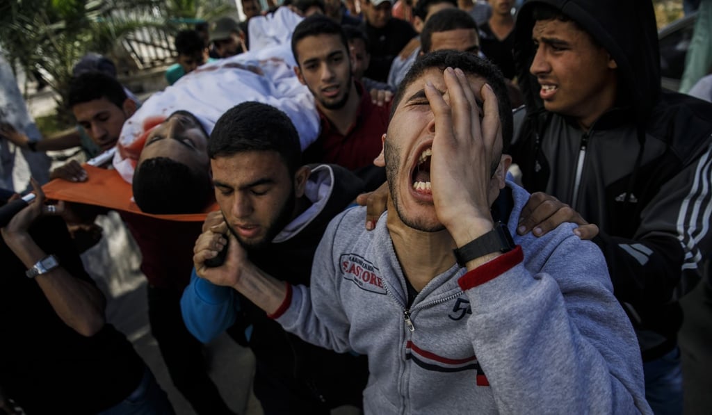 Relatives of Taher Ahmed Madi, 25, carry his body from the Shifa Hospital morgue to his home after he was killed during a protest at the border fence separating Israel and Gaza in a camp east of Gaza City on Monday. Photo: Handout