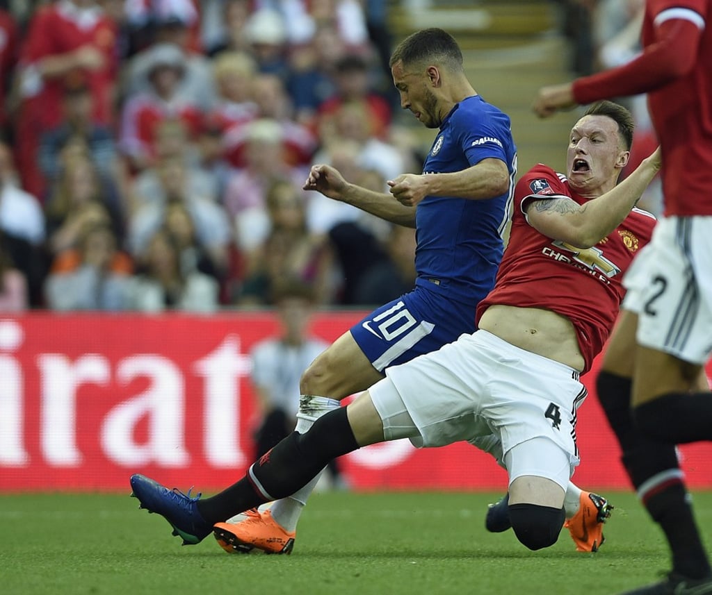 Chelsea’s Eden Hazard is brought down by Phil Jones for a penalty. Photo: EPA