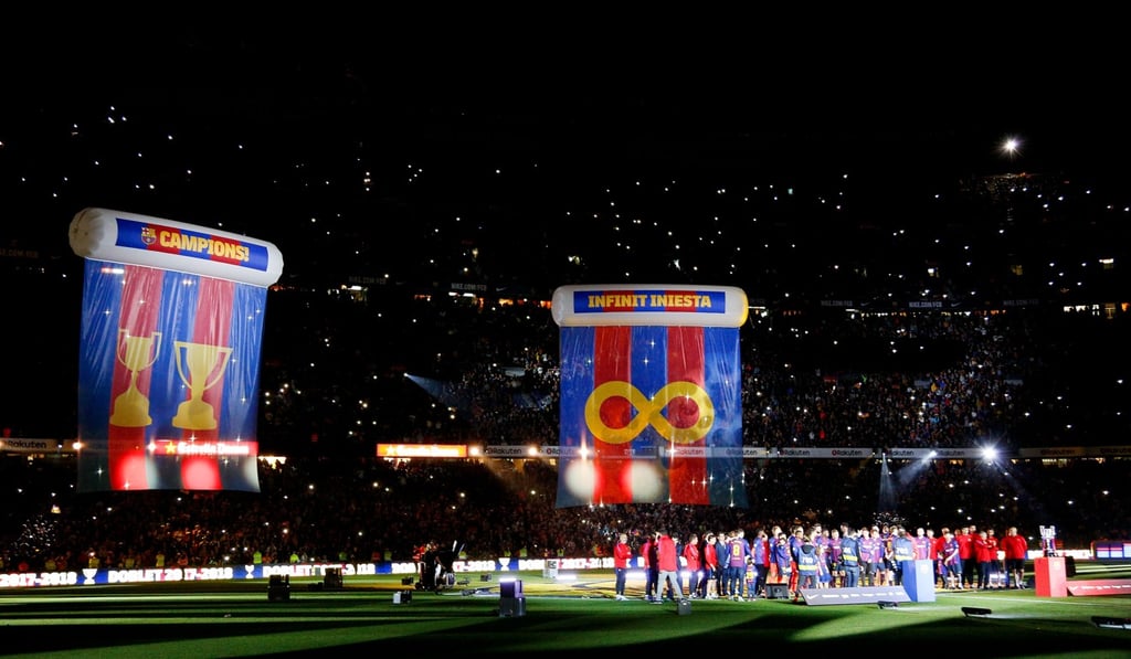 Huge flags hang at the Nou Camp in tribute to Barcelona captain Andres Iniesta. Photo: Xinhua