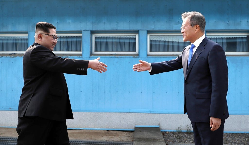 North Korean leader Kim Jong-un (left) prepares to shake hands with South Korean President Moon Jae-in over the military demarcation line in Panmunjom, in the demilitarised zone, on April 27. Photo: Pool via AP North Korean leader Kim Jong-un (left) prepares to shake hands with South Korean President Moon Jae-in over the military demarcation line in Panmunjom, in the demilitarised zone, on April 27. Photo: Pool via AP
