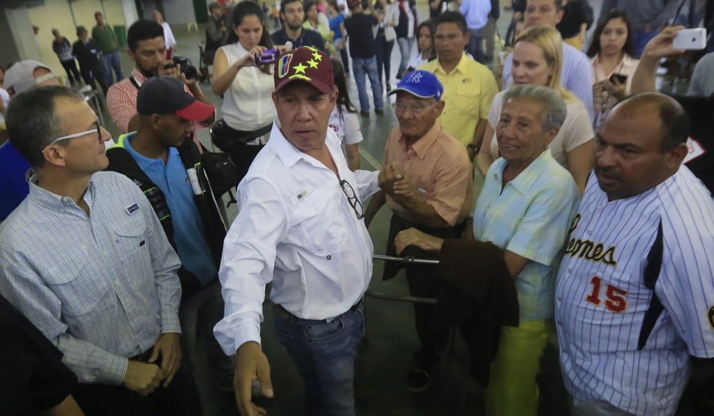 Supporters surround opposition candidate Henri Falcon, former governor and one-time acolyte of Hugo Chavez. Photo: AP Supporters surround opposition candidate Henri Falcon, former governor and one-time acolyte of Hugo Chavez. Photo: AP