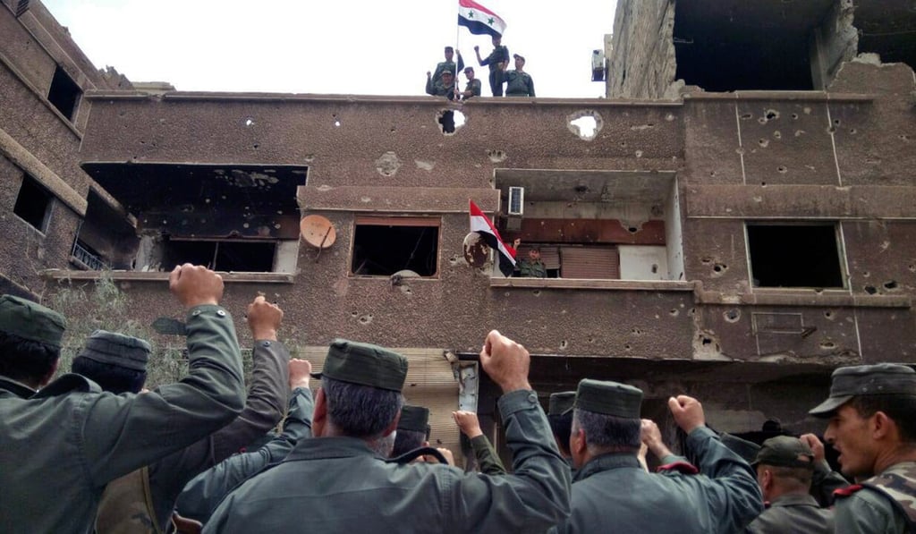 Syrian military and police celebrating. Photo: AP Syrian military and police celebrating. Photo: AP