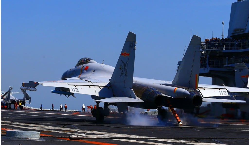A fighter jet lands on China's aircraft carrier, the Liaoning, during a drill in the East China Sea. Photo: AFP