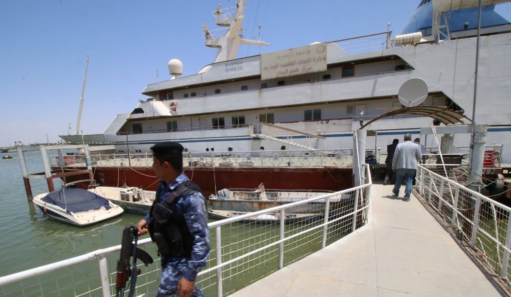 An Iraqi policeman walks past the Basrah Breeze in the southern port of Basra. Photo: Reuters