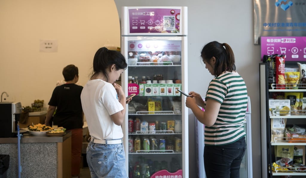 Customers use smartphones to buy groceries from a Mr Fresh unmanned kiosk in Beijing this month. Tencent-backed Mr Fresh, a spin-off of better-established online grocer Miss Fresh, has attracted US$200 million in venture capital. Asian technology stocks account for more than a quarter of the market capitalisation of the MSCI Emerging Markets Index. Photo: Bloomberg