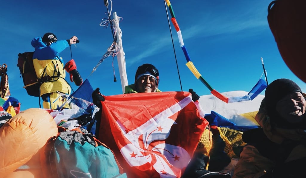 Benjamin Chan at the summit with a Hong Kong flag. Photo: Benjamin Chan