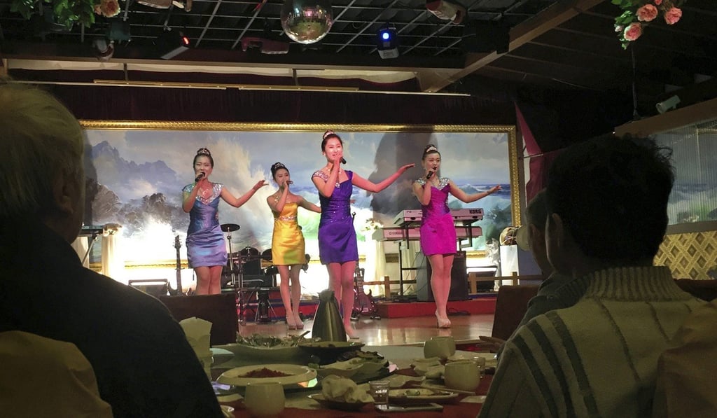 North Korean performers entertain customers at the Okryugwan restaurant in Beijing. Cambodia is still hosting a number of North Korean restaurants despite UN sanctions banning the businesses. Photo: AP