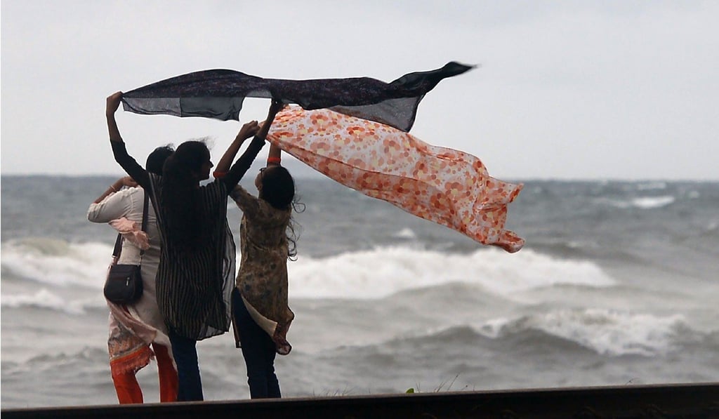 Sri Lankan residents look out from a beach at Dehiwala, a suburb of Colombo on May 20, 2018. Sri Lanka is headed for a debt crisis, the finance ministry warned in May, blaming a series of costly projects commissioned by the previous government for record-high repayments. Photo: AFP