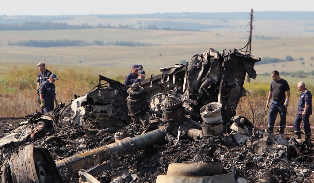 Workers inspect debris at the main crash site of the Boeing 777 Malaysia Airlines flight MH17, which crashed over the eastern Ukraine region on 20 July 2014. Photo: EPA Workers inspect debris at the main crash site of the Boeing 777 Malaysia Airlines flight MH17, which crashed over the eastern Ukraine region on 20 July 2014. Photo: EPA