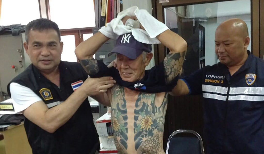 Thai police parade Japanese crime boss Shigeharu Shirai – and his tattoo filled torso – 14 years after he went on the run. Photo: AFP