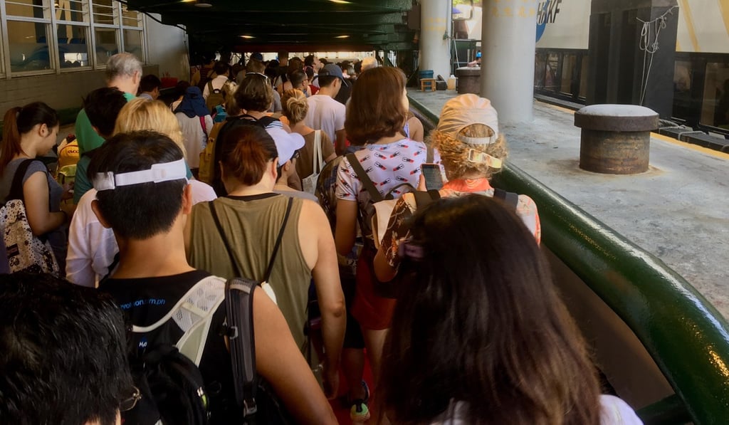 Long queues of volunteers making their way onto the ferry for the clean-up. Photo: Kylie Knott