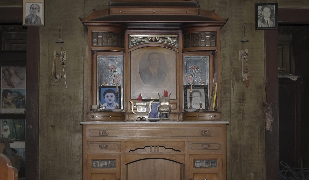 Frida Listiyani prays for her late husband's ancestors at this altar in the home she shared with her late husband. Photo: Valerian Timothy