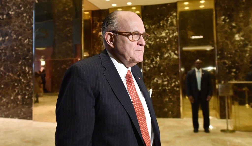 Former New York City mayor Rudy Giuliani walks toward members of the media in the lobby of the Trump Tower in this file photo. Photo: TNS