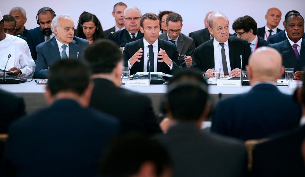 French President Emmanuel Macron, flanked by French Minister of Europe and Foreign Affairs Jean-Yves Le Drian and UN Special Envoy for Libya, Lebanese Ghassan Salame speaks during an International conference on Libya at the Elysee Palace in Paris, on May 29. Photo: AFP