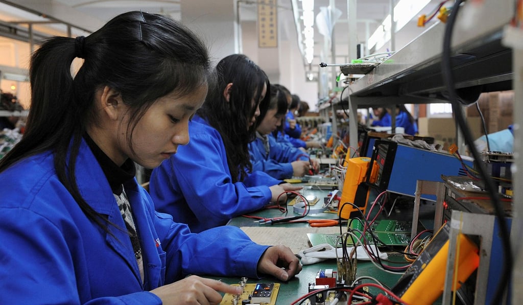 Workers assemble remote controls of air conditioners and water heaters along a production line at a factory in Hefei, Anhui province, China, in December 2010. Photo: Reuters