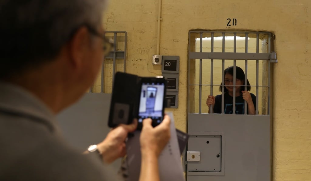 Visitors posed for photographs in the old prison at Tai Kwun. Photo: Sam Tsang