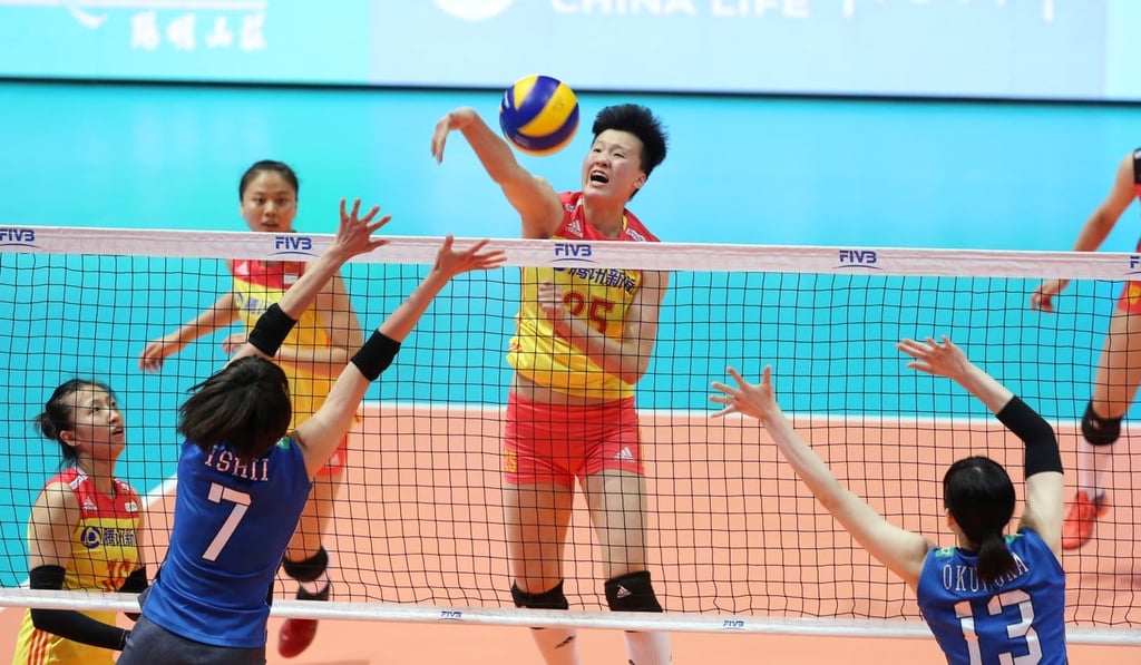 China’s Hu Mingyuan spikes past the Japan defence.