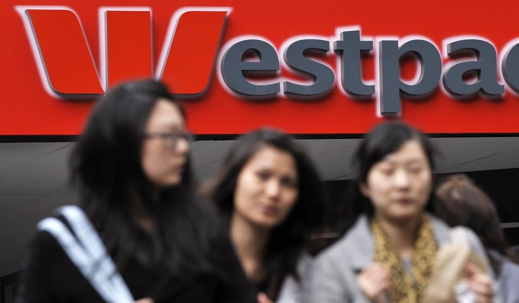 Women walk by a Westpac sign in Melbourne in May 2009. Westpac is one of Australia’s four big banks investigated under the royal commission. Photo: AFP