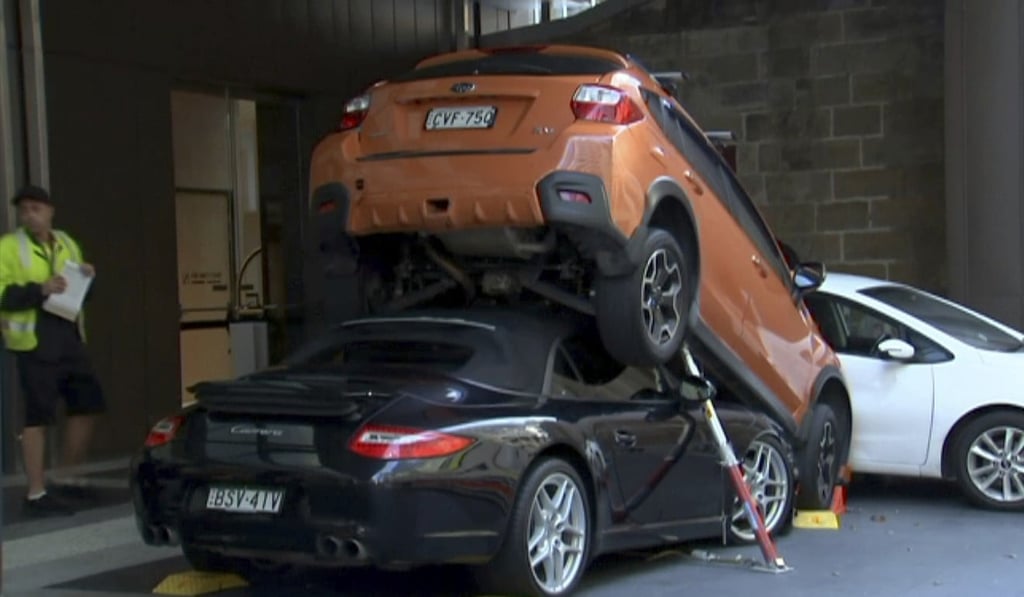 The Porsche Carrera underneath the other vehicle. Photo: AP