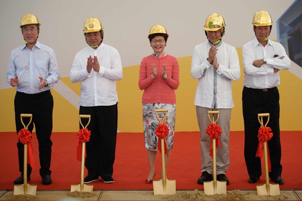 Hong Kong Chief Executive Carrie Lam and other guests applaud after using shovels to dig up sand at a ceremony for the Hong Kong Palace Museum in the West Kowloon Cultural District on May 28. The Palace Museum, due to open in 2022, will showcase a collection loaned from the Palace Museum in Beijing. Photo: AFP Hong Kong Chief Executive Carrie Lam and other guests applaud after using shovels to dig up sand at a ceremony for the Hong Kong Palace Museum in the West Kowloon Cultural District on May 28. The Palace Museum, due to open in 2022, will showcase a collection loaned from the Palace Museum in Beijing. Photo: AFP