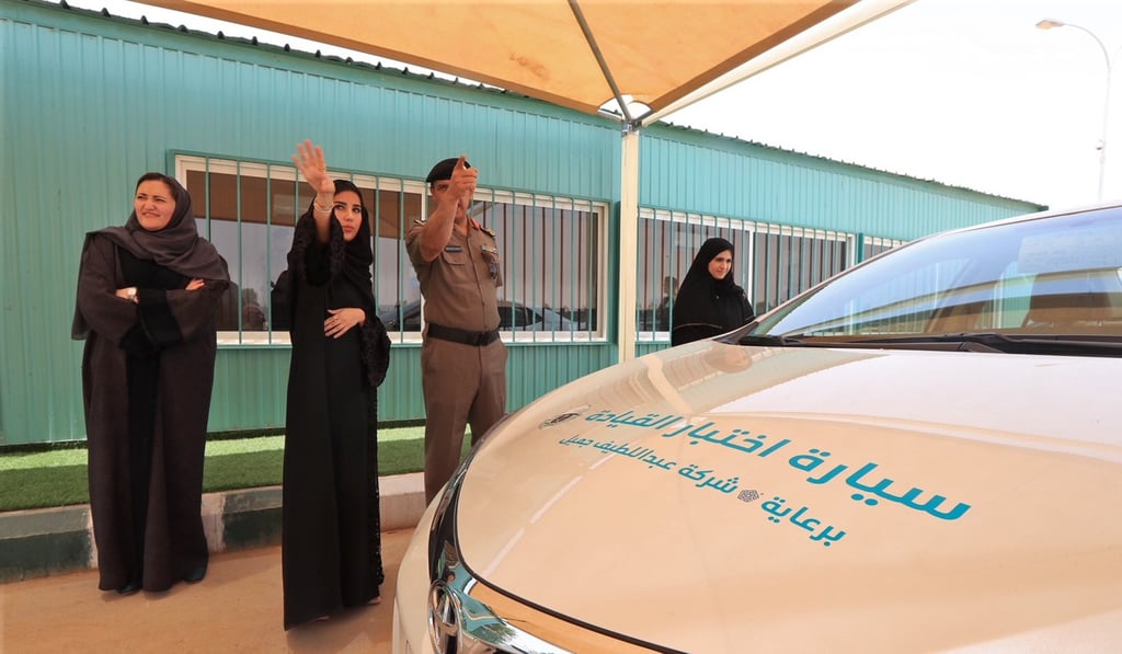 A Saudi woman speaking with an officer before her driving test at the General Department of Traffic in Riyadh on Monday. Photo: Saudi Information Ministry via AP