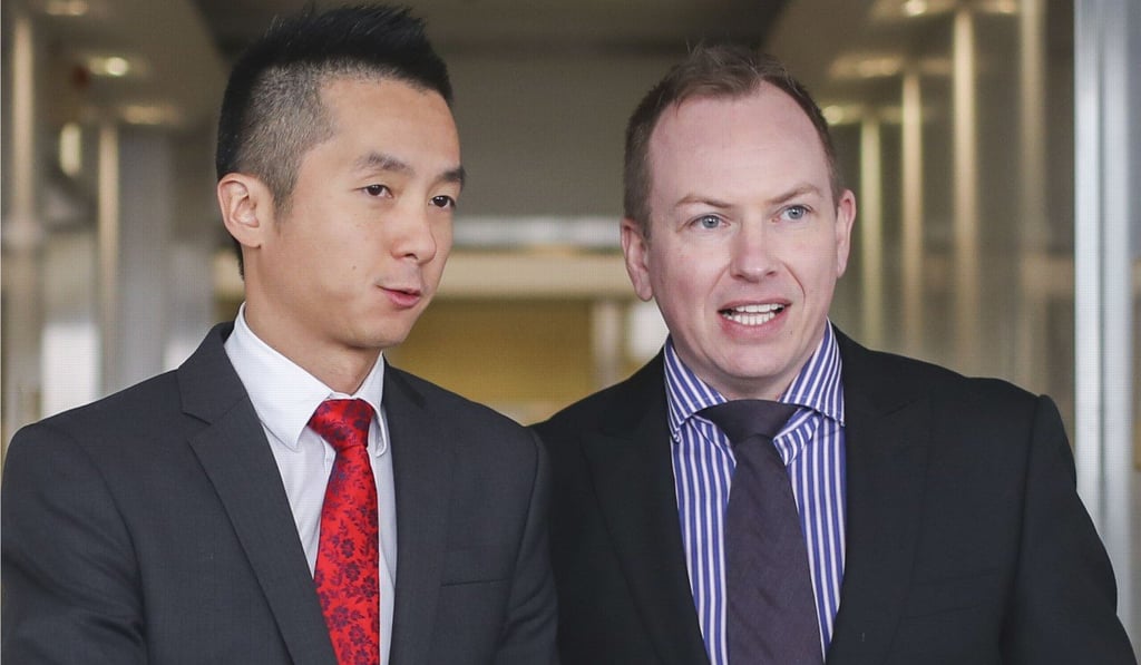 Senior immigration officer Angus Leung and his partner Scott Adams leave the High Court last December after attending the appeal hearing. The Court of Appeal last week overturned an earlier ruling which granted the couple spousal benefits available to heterosexual couples. Photo: Winson Wong