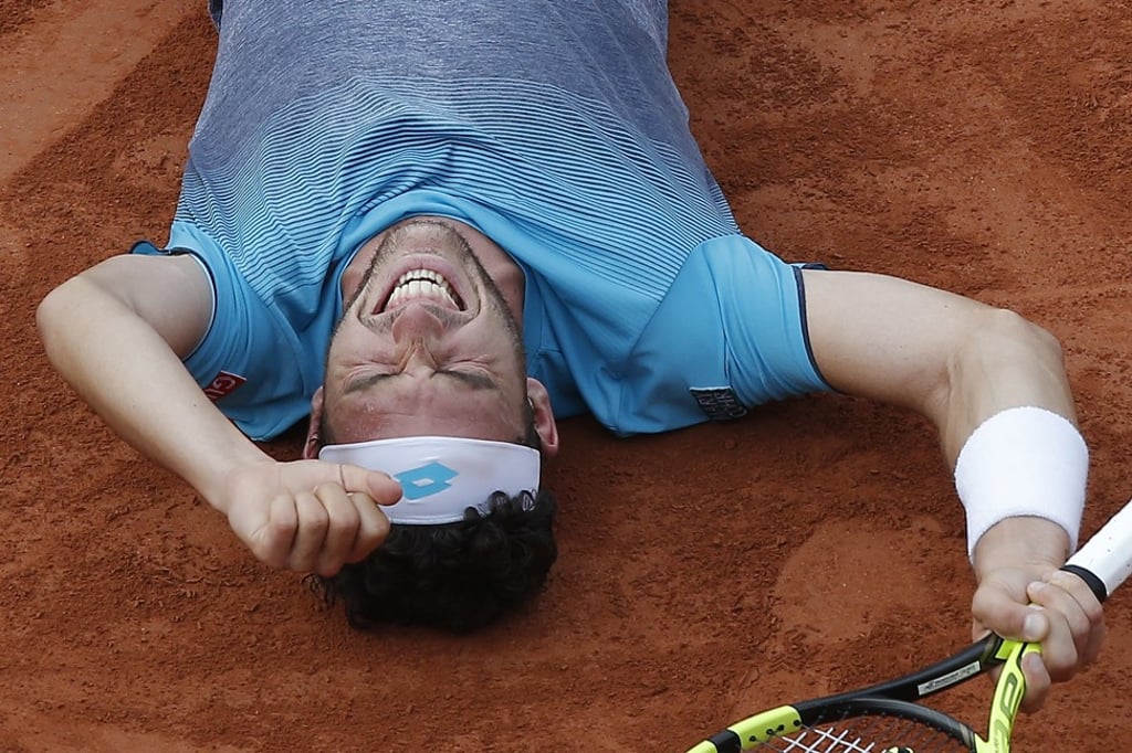 Marco Cecchinato sprawled on the clay after defeating Novak Djokovic. Photo: AP Marco Cecchinato sprawled on the clay after defeating Novak Djokovic. Photo: AP