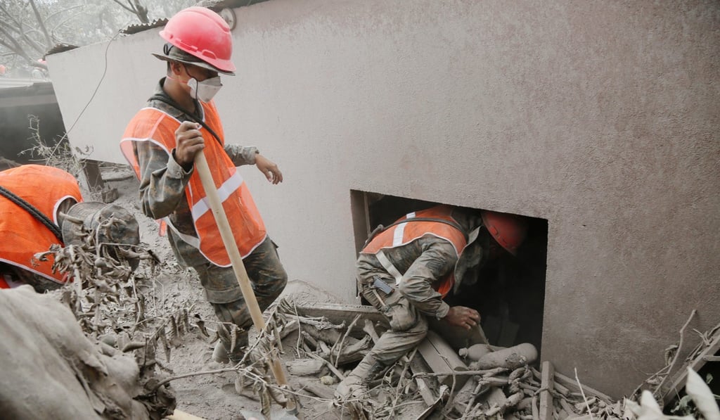 Soldiers inspect an area affected by the eruption of the Fuego volcano in the community of San Miguel Los Lotes in Escuintla, Guatemala, on Tuesday. Photo: Reuters
