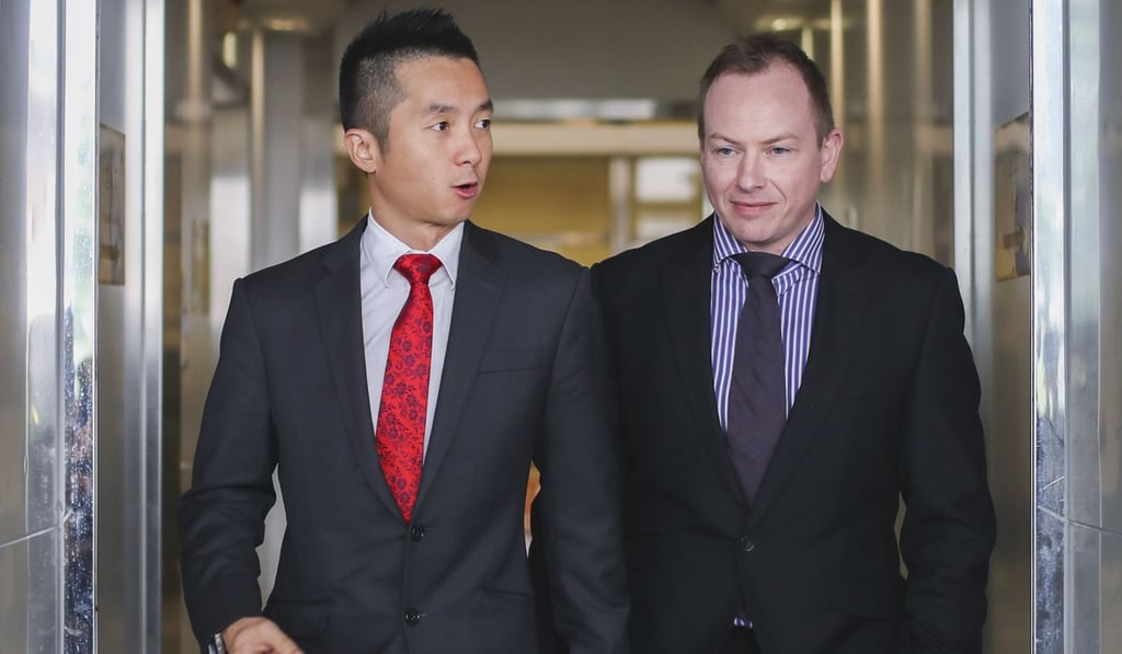 Senior immigration officer Angus Leung (left) and his partner Scott Adams leave the High Court in Admiralty in December 2017. Leung lodged a judicial challenge after his same-sex partner was refused spousal benefits. Photo: Winson Wong