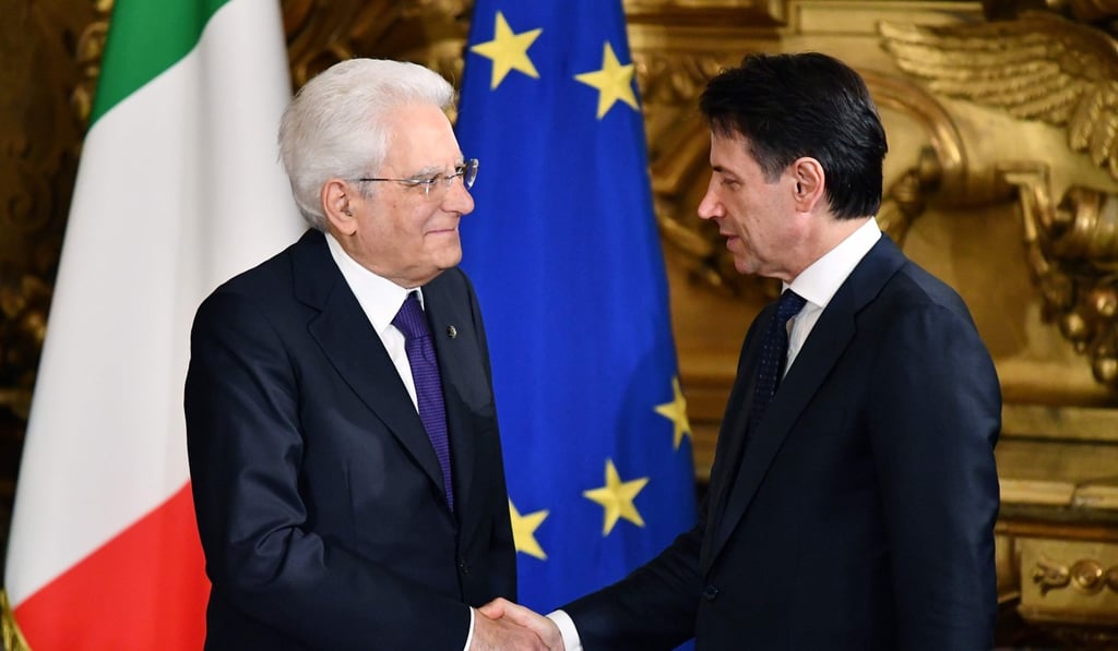 Italy’s President Sergio Mattarella (left) shakes hands with Prime Minister Giuseppe Conte during the swearing-in ceremony of the new government at Quirinale Palace in Rome on June 1. The coalition has a broadly anti-immigration and anti-euro-zone stance. Photo: AFP