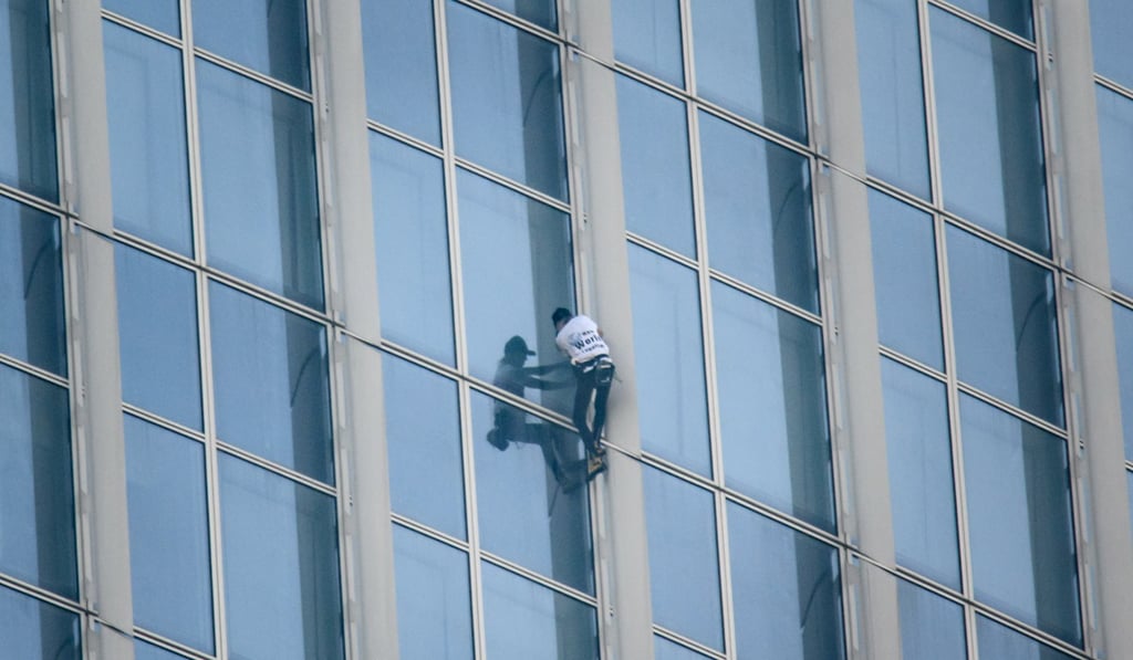 France’s Alain Robert scales the exterior of the Lotte World Tower in Seoul before being ordered inside by authorities. Photo: AFP France’s Alain Robert scales the exterior of the Lotte World Tower in Seoul before being ordered inside by authorities. Photo: AFP
