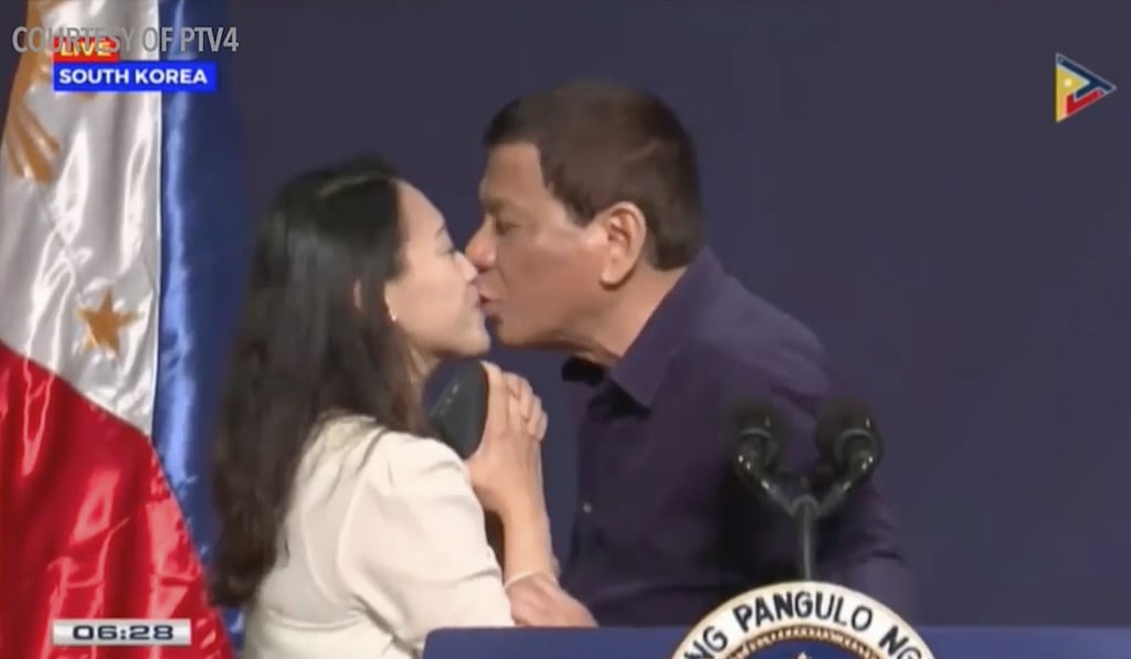 Philippine President Rodrigo Duterte kisses overseas worker Bea Kim in Seoul, South Korea. Photo: AP