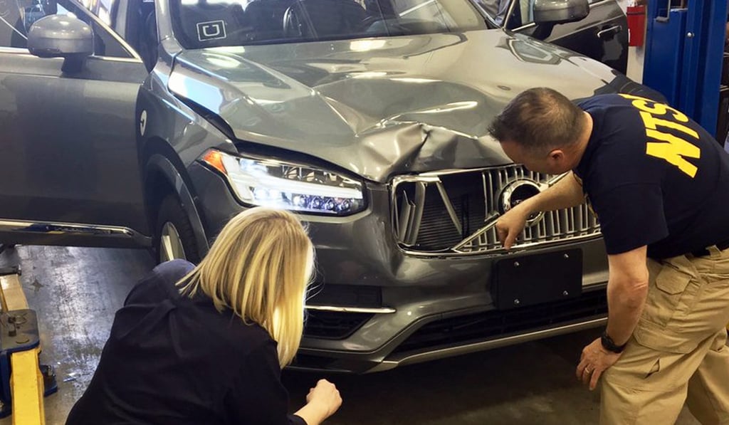 Investigators examine an Uber car that fatally struck a woman in Tempe, Arizona in March. Photo: National Transportation Safety Board via AP