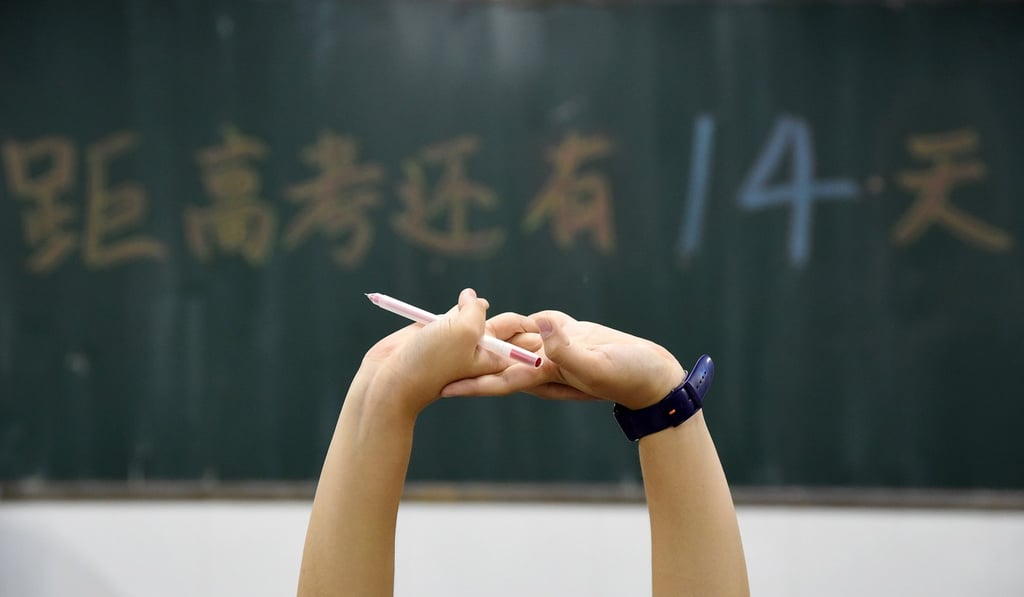 A Chinese high school student stretches while studying for gaokao, widely considered to be the most important exam that will determine future education and career paths. Photo: EPA