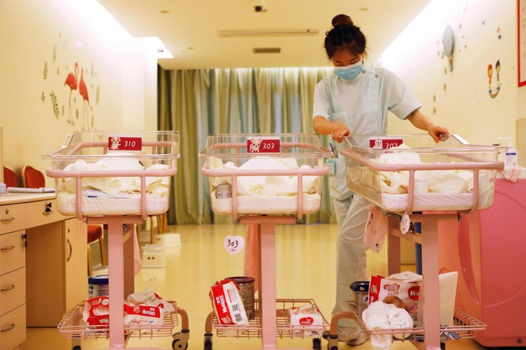 A staff member takes care of babies at a care centre in Shanghai. Mothers pay up to 70,000 yuan (US$10,900) a month to stay at the facility with their newborns. Photo: AFP A staff member takes care of babies at a care centre in Shanghai. Mothers pay up to 70,000 yuan (US$10,900) a month to stay at the facility with their newborns. Photo: AFP