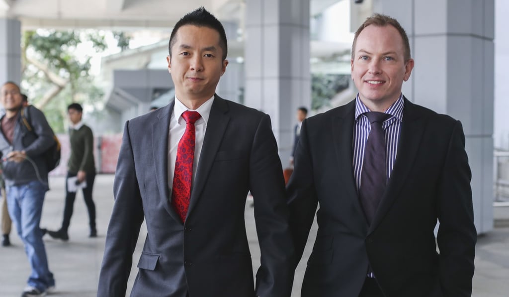 Senior immigration officer Angus Leung and his partner Scott Adams leave the High Court last December after attending the appeal hearing. The Court of Appeal overturned an earlier ruling which granted the couple spousal benefits available to heterosexual couples. Photo: Winson Wong