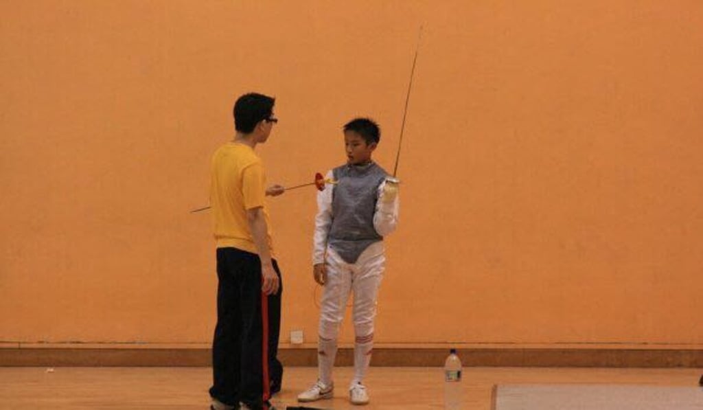 Ryan Choi learns the art of fencing as a young boy. Photo: Handout Ryan Choi learns the art of fencing as a young boy. Photo: Handout