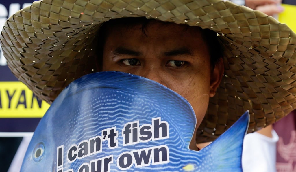 A protester outside the Chinese consulate in Makati, Philippines. Photo: EPA A protester outside the Chinese consulate in Makati, Philippines. Photo: EPA