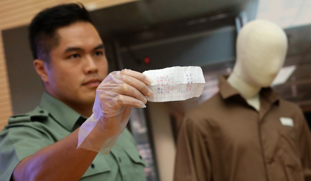 An officer displays an illicit betting slip. Photo: Felix Wong