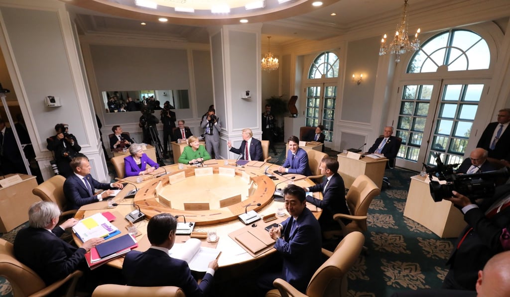 Leaders of the G7 participate in a working session of the G7 Summit in La Malbaie, Quebec, Canada, on Friday. Seated clockwise from top center-left: German Chancellor Angela Merkel (in green); US President Donald Trump; Canadian Prime Minister Justin Trudeau; French President Emmanuel Macron; Japanese Prime Minister Shinzo Abe; Italian Prime Minister Giuseppe Conte; President of the European Commission Jean-Claude Juncker; President of the European Council Donald Tusk; and British Prime Minister Theresa May. Photo: pool via EPA-EFE