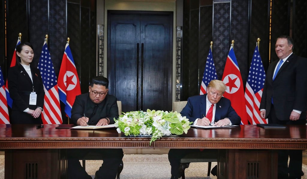 US Secretary of State Mike Pompeo and North Korean leader's sister Kim Yo-jong look on as US President Donald J. Trump and North Korean Chairman Kim Jong-un sign the joint statement in Singapore. Photo: EPA US Secretary of State Mike Pompeo and North Korean leader's sister Kim Yo-jong look on as US President Donald J. Trump and North Korean Chairman Kim Jong-un sign the joint statement in Singapore. Photo: EPA