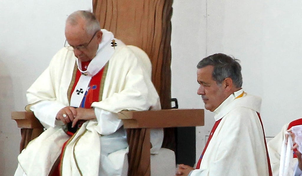 Pope Francis, seated, with the bishop of Osorno, Juan Barros, during an open-air mass in Temuco, Chile, on January 17. Barros is one of three bishops whose resignations the pope accepted on Monday following a sex abuse scandal in the Chilean church. Photo: AFP