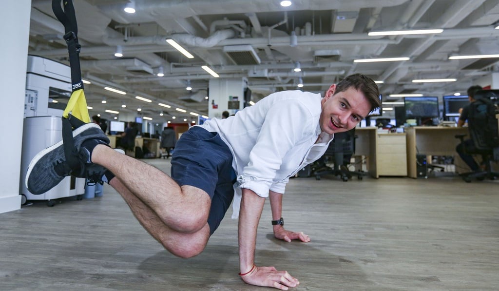 Chengbao talent acquisition officer Maxime Danjoux tries TRX cables at his company’s office in Wan Chai. Photo: Xiaomei Chen