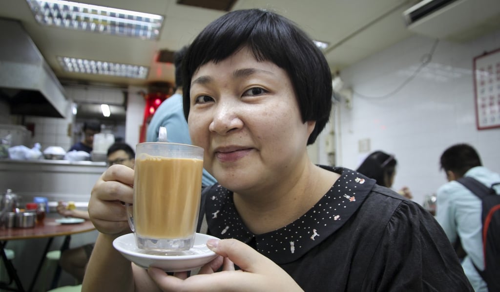 Hong Kong food writer Emily Tong Lai-fong enjoying a Hong Kong-style milk tea at Wai Kee Noodle Cafe in Sham Shui Po. Photo: Alkira Reinfrank